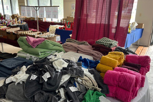 Stacks of donated supplies including boxes and essential goods, prepared for distribution to communities affected by the storm.