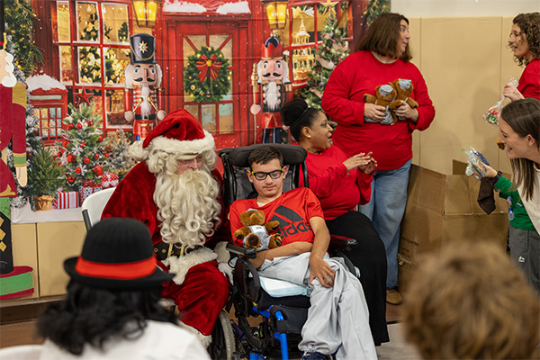 Children participate in a quiet, indoor holiday celebration designed to provide a safe and welcoming experience for those with sensory sensitivities.