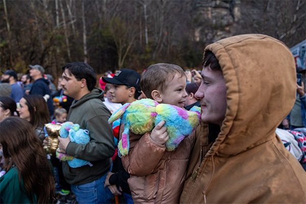 Children and caregivers receive winter accessories and holiday gifts provided through the CSX Santa Train.