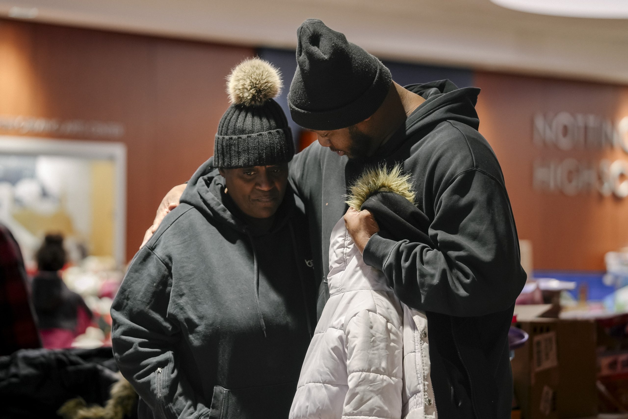 Two women hug at a distribution in Los Angeles