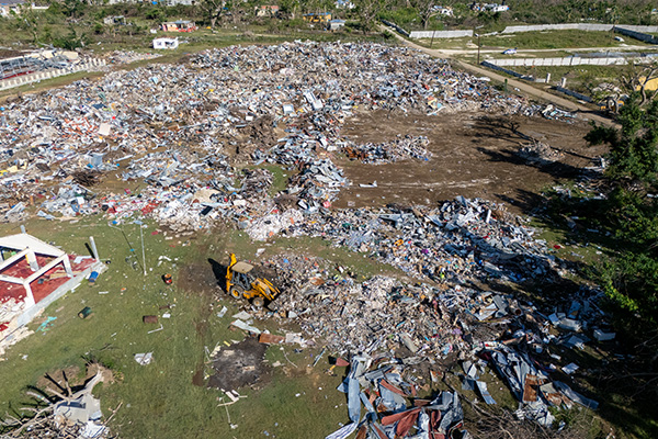 Aerial view of debris and cleanup efforts in Jamaica months after Hurricane Melissa.
