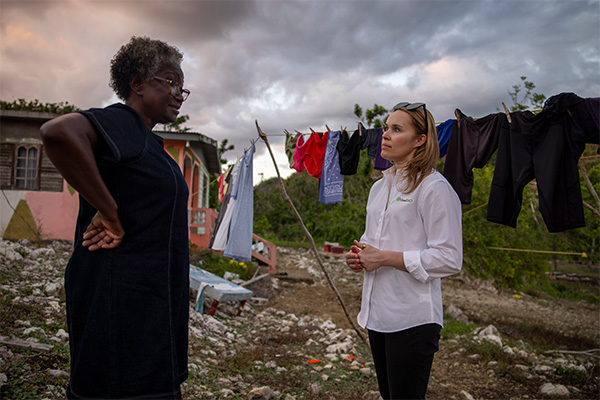 Morgan Loomis of Good360 speaks with a Jamaican resident during a long-term recovery needs assessment following Hurricane Melissa.
