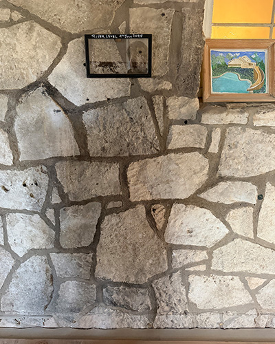 Handwritten water level markings inside a Kerrville home showing the height reached during historic flooding.