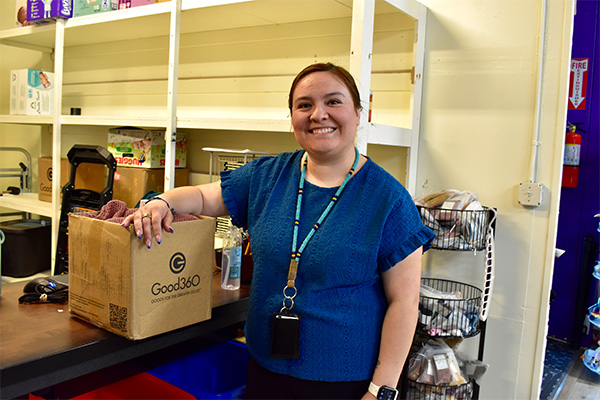 Community social worker Bri Reyes holds a Good360 donation box at Sweet Potato's Closet in Hermiston, Oregon