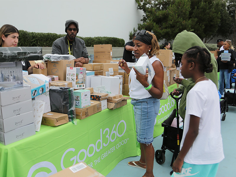 Volunteers sorting donated goods and products at a community distribution event