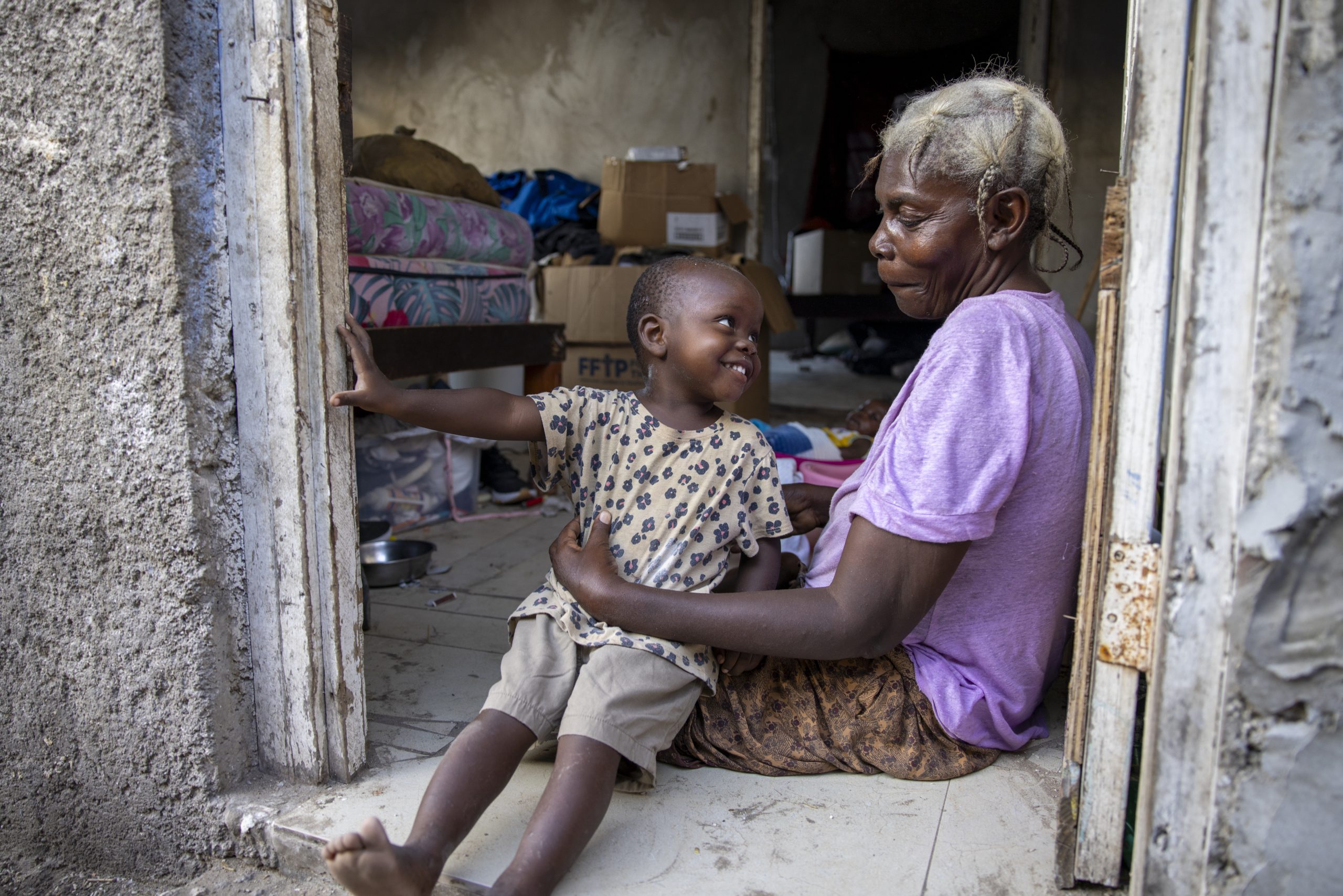 A woman and toddler share a sweet smile in Parottee, Jamaica, where Good360 distributed donated netting to local fisherfolk.