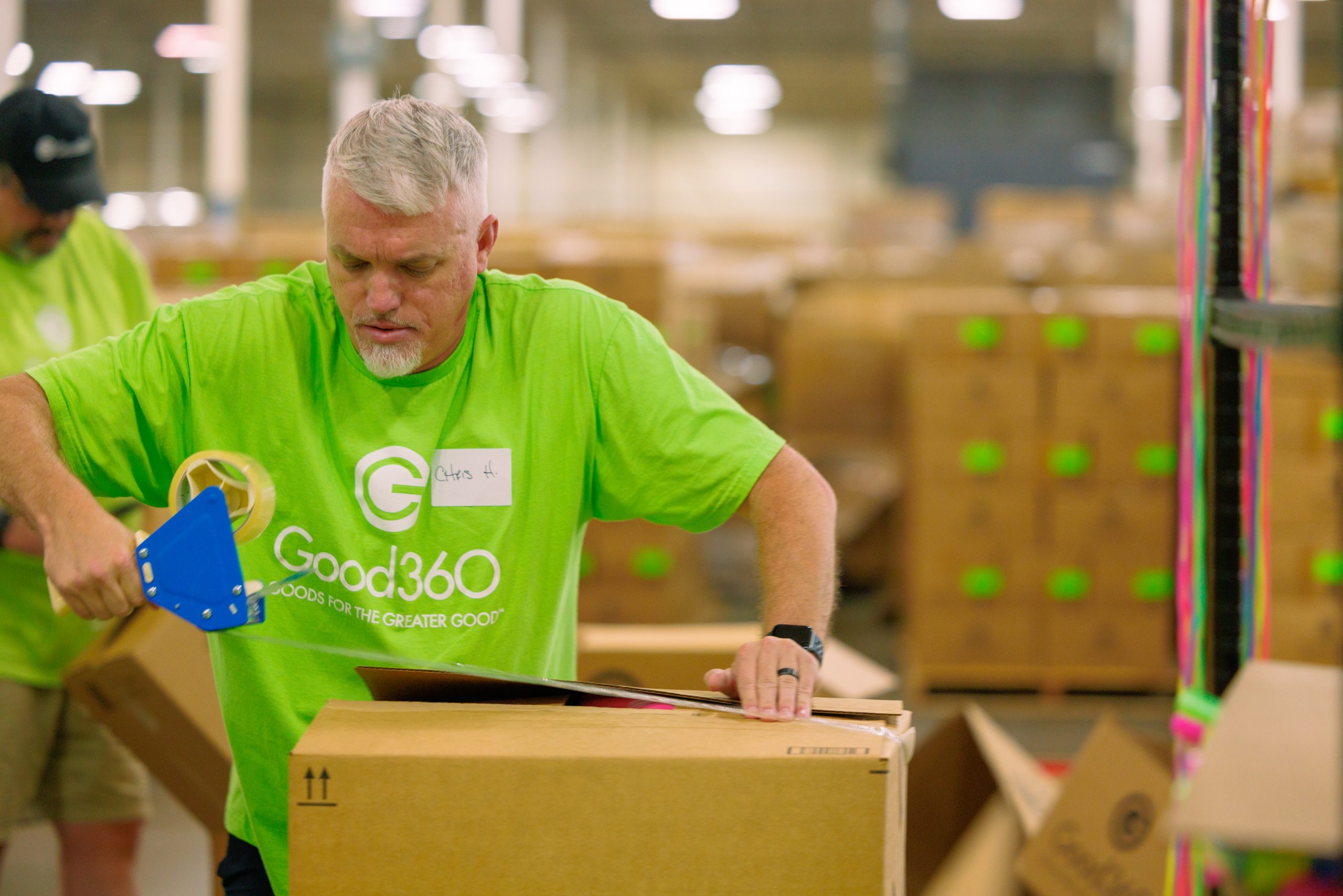 A volunteer tapes up a box of donated goods at a Good360 warehouse in Maysville, Kentucky.