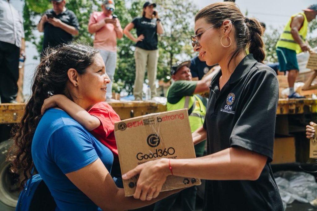 A volunteer gives donated products to a recipient affected by the earthquakes in Venezuela.